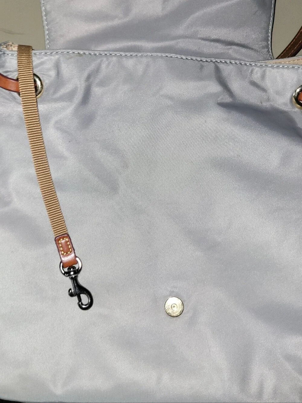 Dooney & Bourke Light Gray Nylon Backpack with Brown Leather Trim.